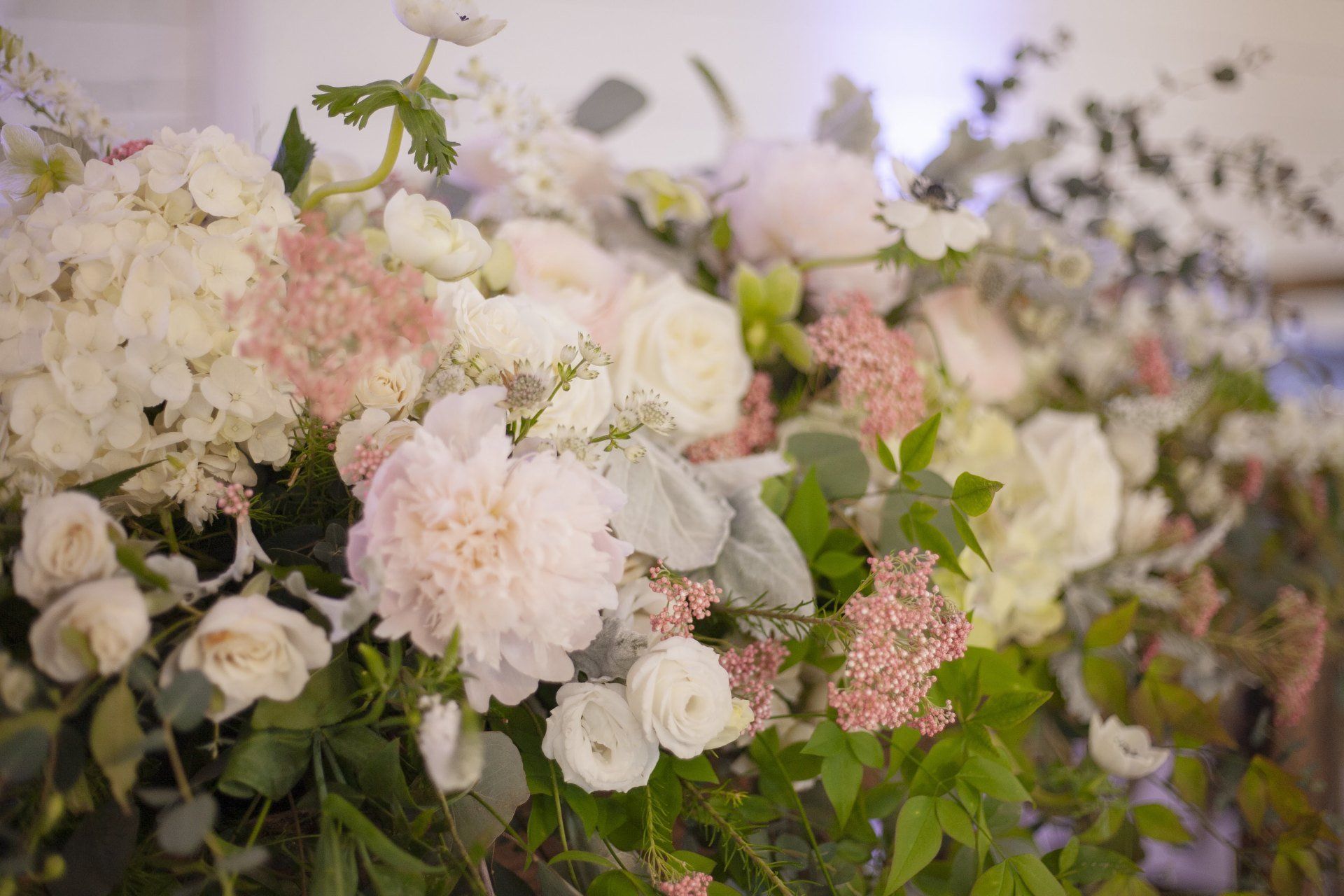 Pastel white and pink floral arrangement with hydrangeas and roses