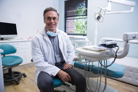 Financial Consultant — Smiling Doctor Sitting On Chair in Raleigh, NC Financial Consultant — Smiling Doctor Sitting On Chair in Raleigh, NC