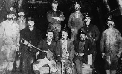 Coal workers covered in coal dust