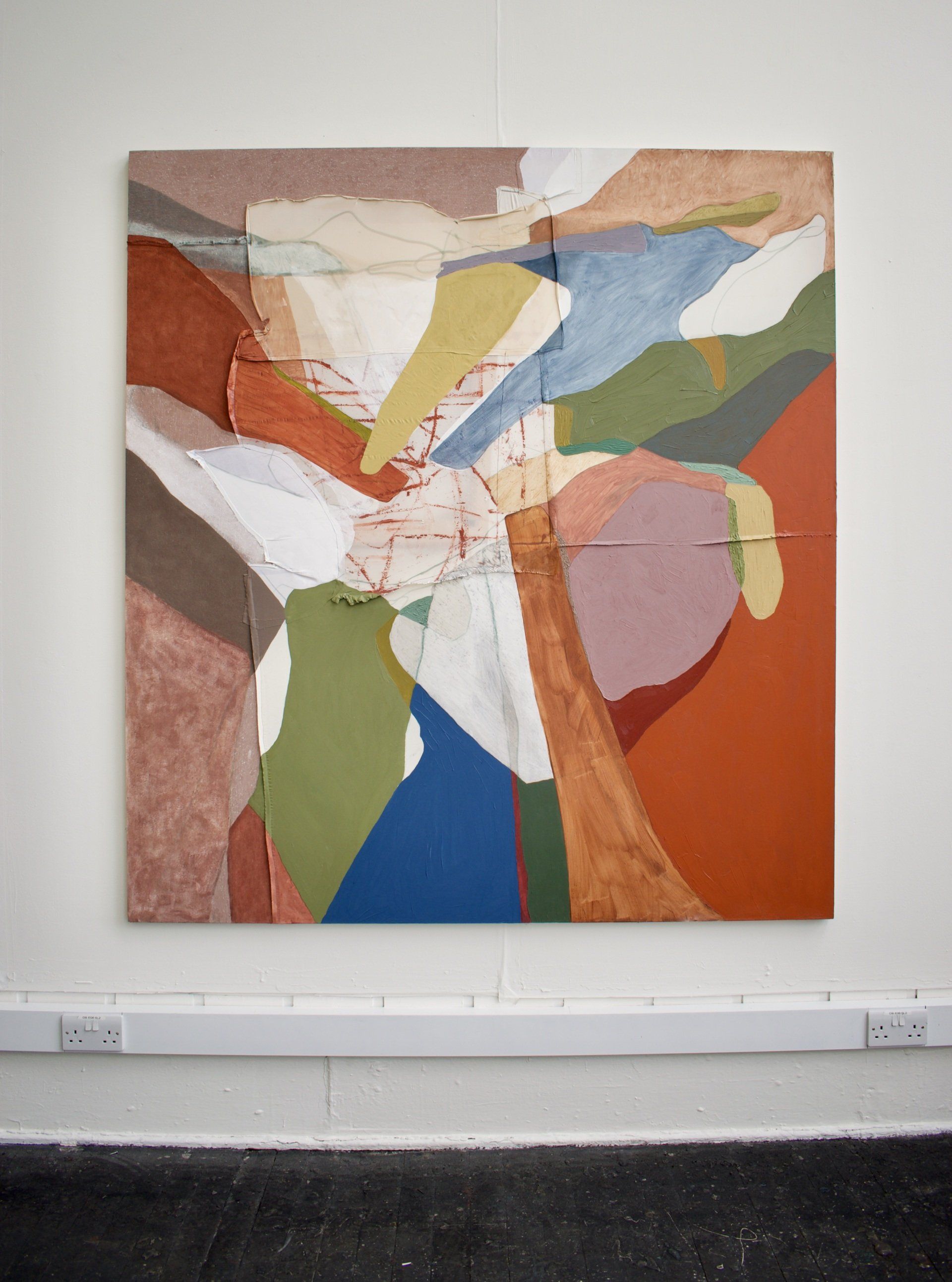 Colourful abstract landscape painting hanging on white gallery wall