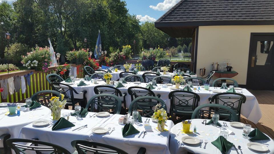 A patio with tables and chairs set up for a party