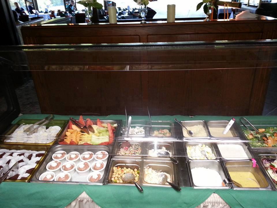 A buffet with a lot of different types of food