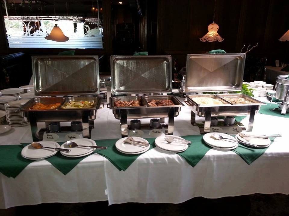 A buffet table with plates and utensils on it