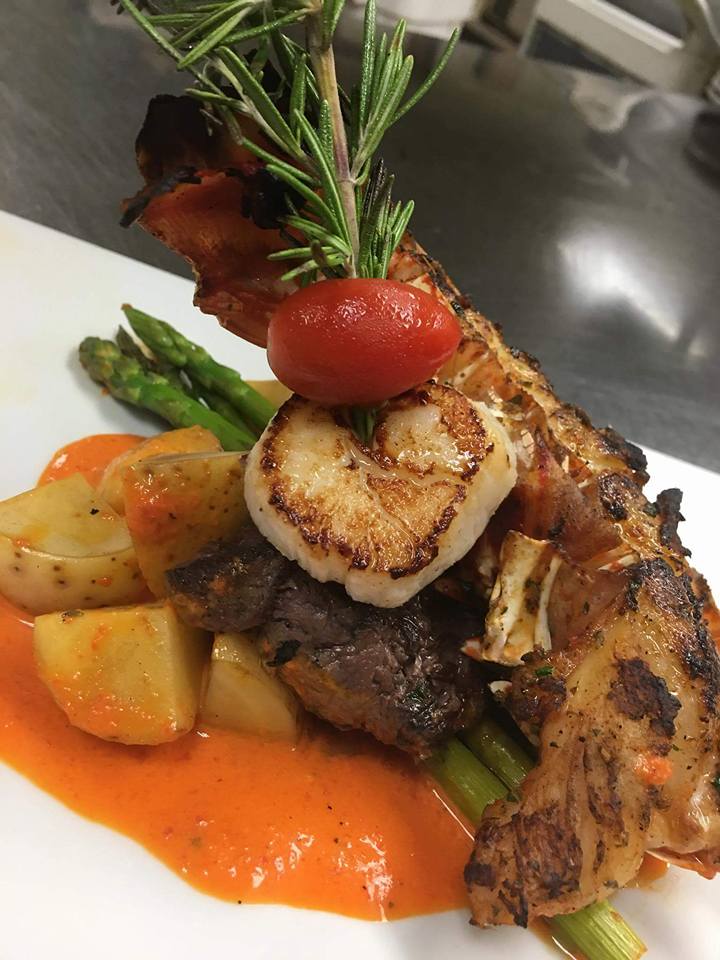 A close up of a plate of food with meat , vegetables and sauce on a table.