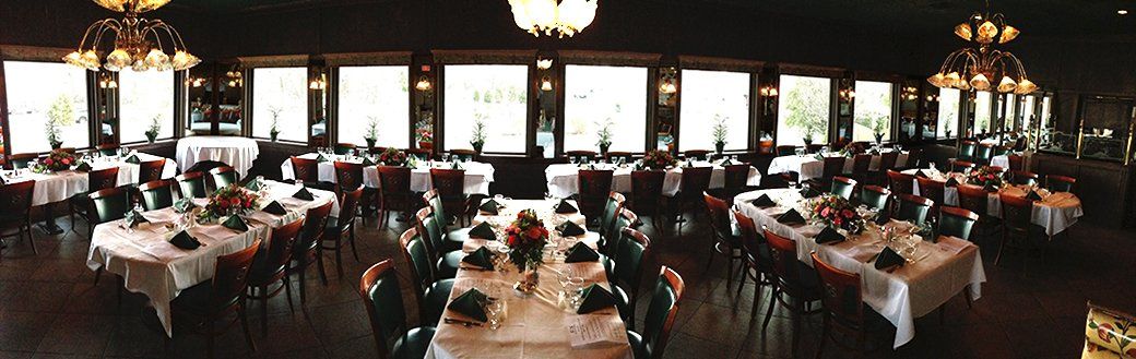 A large room filled with tables and chairs and a chandelier.