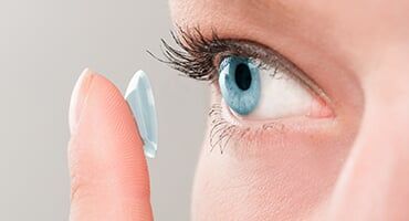 Woman Wearing Contact Lens—Eye Doctor in Edina, MN Woman Wearing Contact Lens—Eye Doctor in Edina, MN