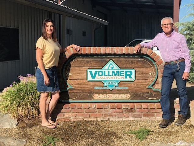 Construction Site Excavation — Bob Standing Near The Vollmer Signage in Fresno County, CA