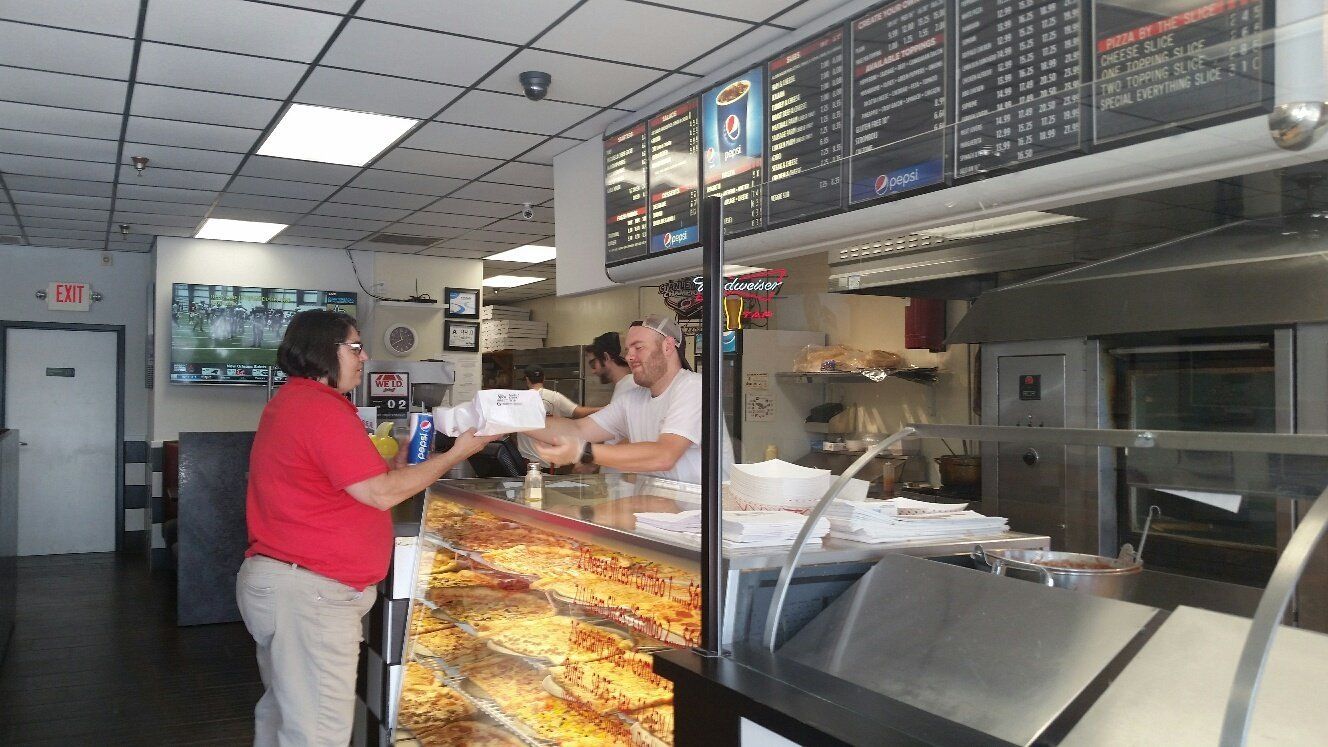 woman picking up order from counter