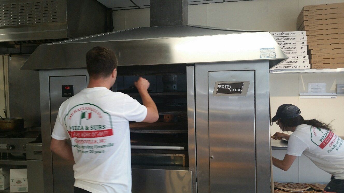 checking on food in multi-level rotating oven