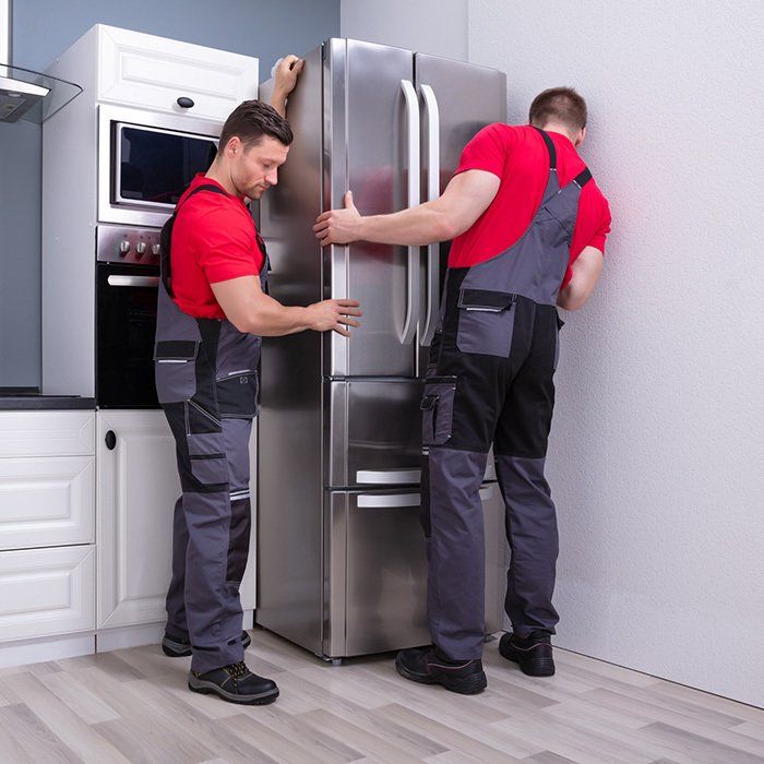 Two Man Installing the Refrigerator — Timberville, VA — Matt’s Appliance Service Inc
