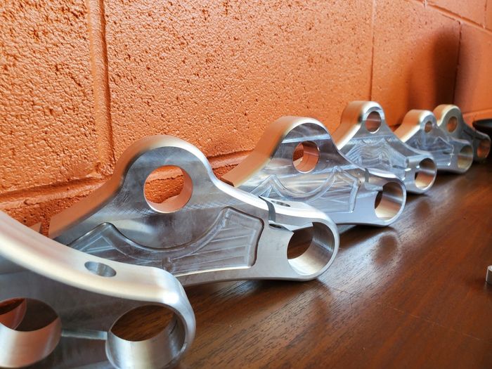 A row of metal pieces sitting on a wooden table