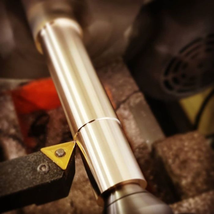 A piece of metal is being worked on by a machine