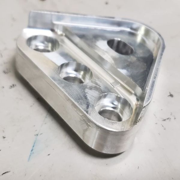 A piece of metal with holes in it is sitting on a table