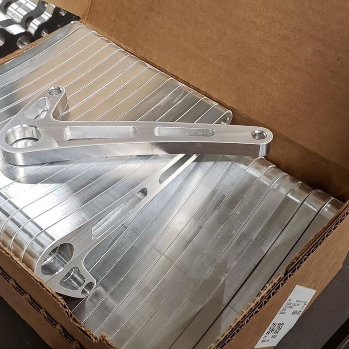 A cardboard box filled with aluminum pieces and a piece of metal