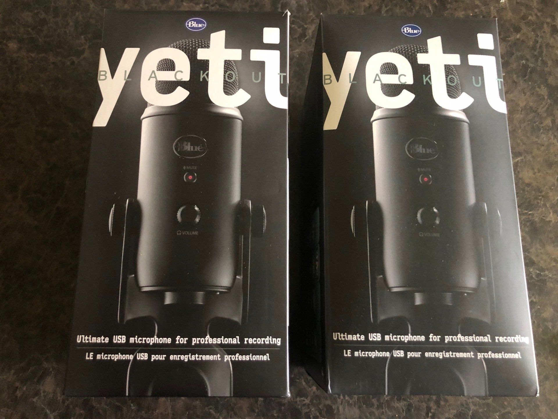 Two boxes of yeti microphones on a table