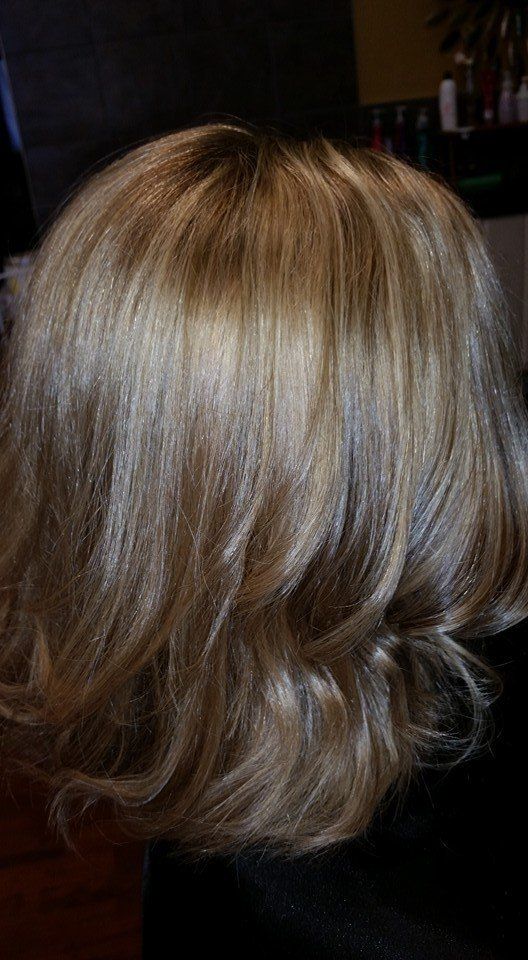 A close up of a woman's dirty-blonde hair in a salon.