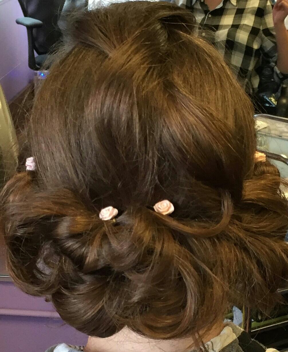A close up of a woman's hair with flowers in it.