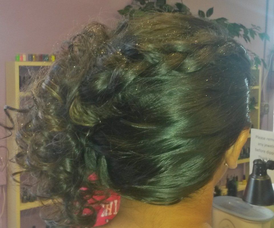 The back of a woman's head with her hair in a braid.