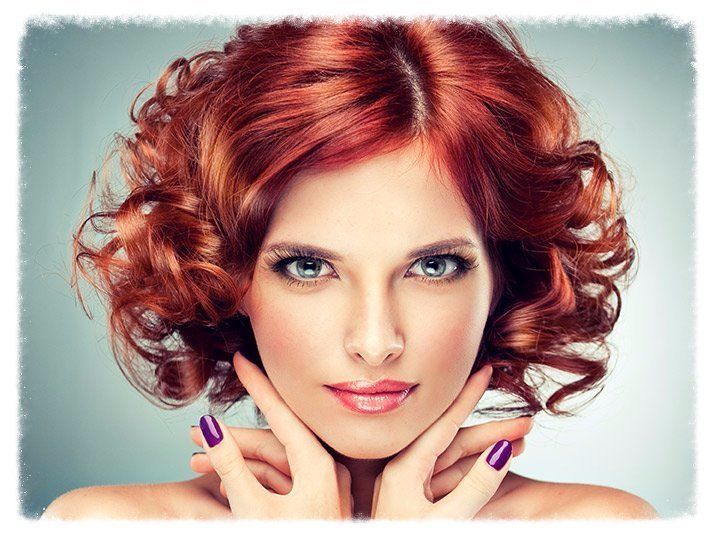 Woman with a new hair style, eyelash extensions and polished nails.
