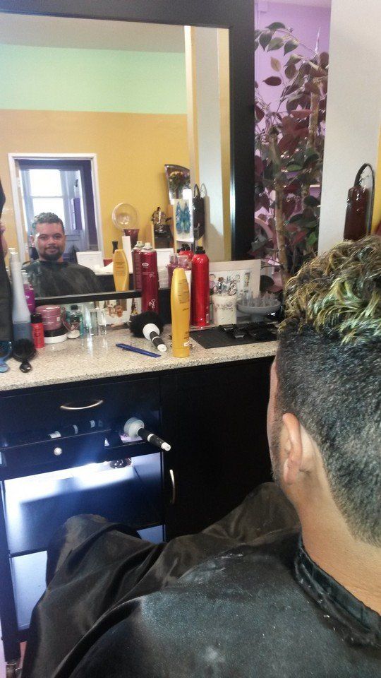 A man is getting his hair cut in a salon.