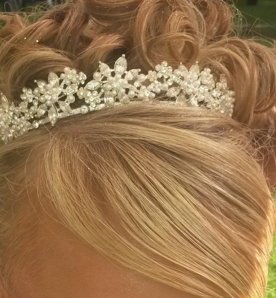 A woman is wearing a tiara in her hair.