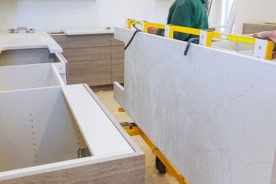 Workers Lifting and Installing with Maple Granite Counter — Oroville, CA — Custom Tile & Granite Workers Lifting and Installing with Maple Granite Counter — Oroville, CA — Custom Tile & Granite