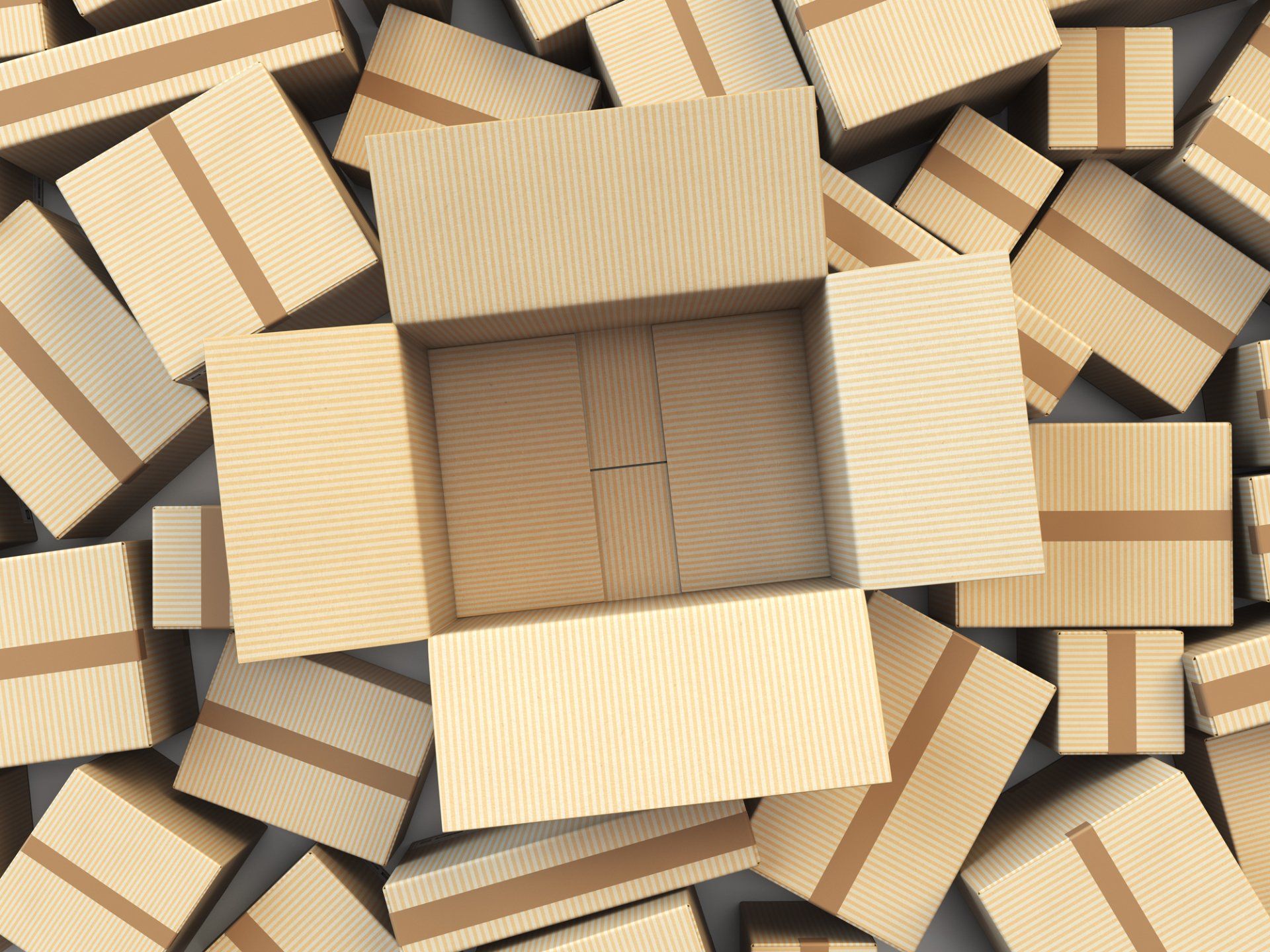 An open cardboard box surrounded by many closed cardboard boxes.