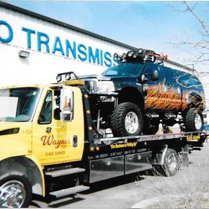 SUV on Tow Truck - Tow Truck Services and Equipment Hauling in Pueblo,CO and the Surrounding Area SUV on Tow Truck - Tow Truck Services and Equipment Hauling in Pueblo,CO and the Surrounding Area