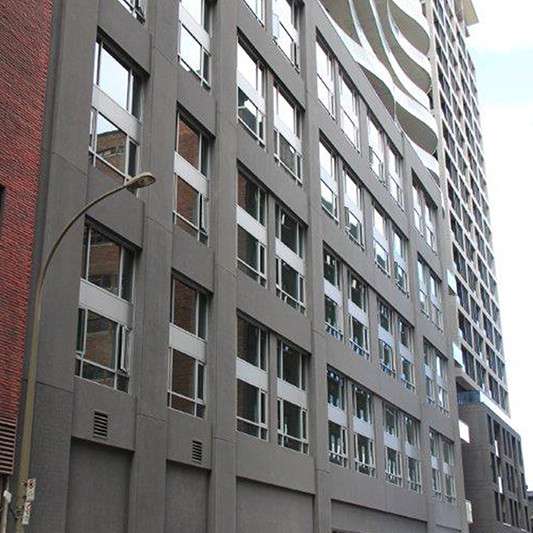 A tall building with a lot of windows and a street light
