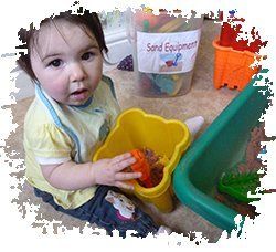 baby playing with sand