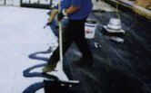 Roofing Contractor Equally Applying Tar to Roof - Hot Tar Roofing in Swansboro, North Carolina