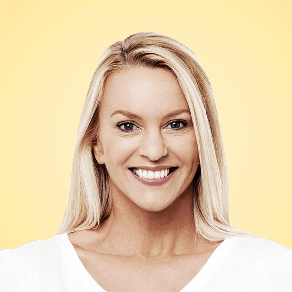 Blonde woman smiling, white top, against yellow background.