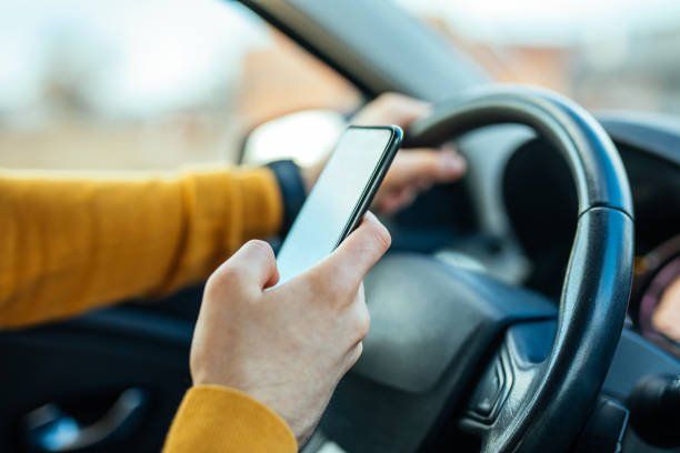 Male Using Mobile Phone While Driving The Car — Indianapolis, IN — Wegner C Dennis & Assoc Male Using Mobile Phone While Driving The Car — Indianapolis, IN — Wegner C Dennis & Assoc