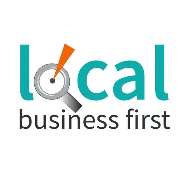 A logo for local business first with a magnifying glass