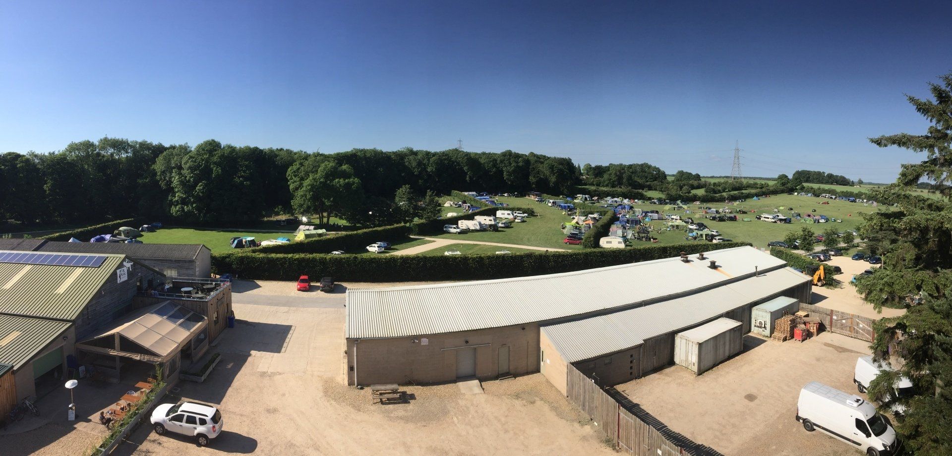 An aerial view of a large field with lots of buildings and trees.