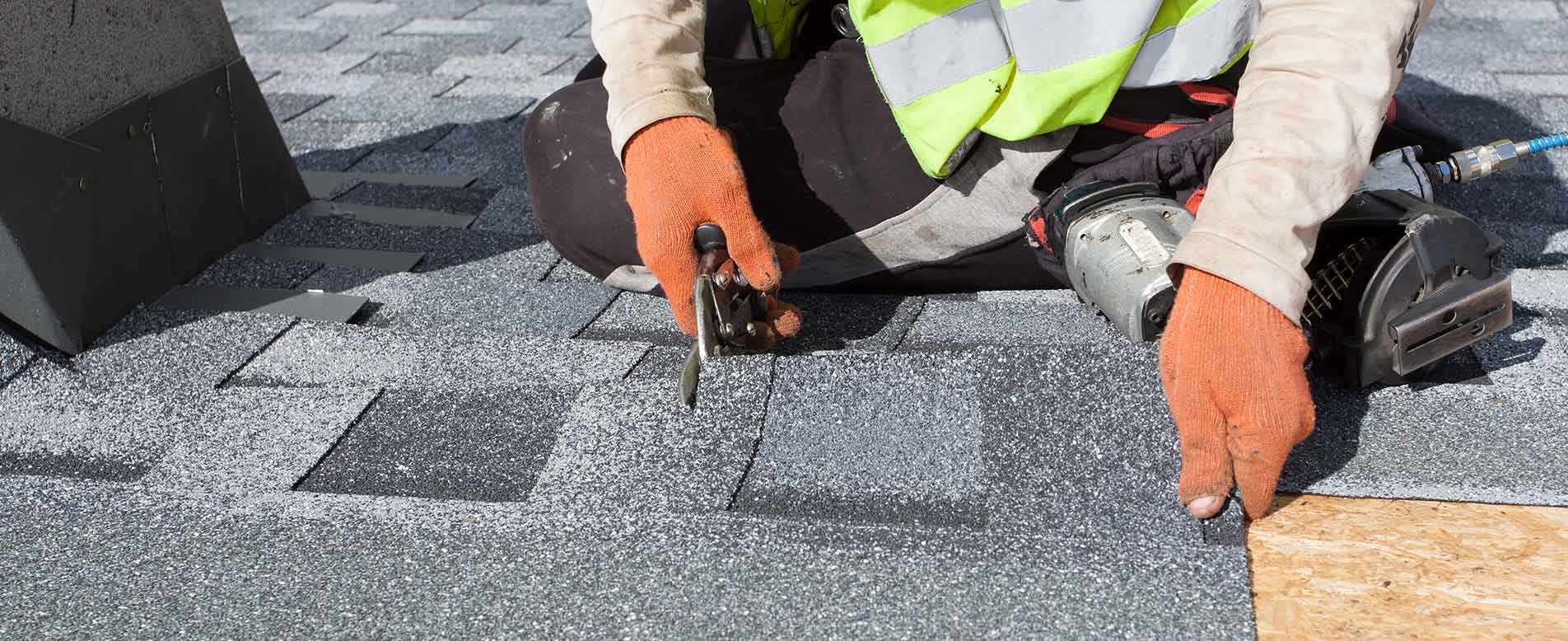 Roofer installing shingles.