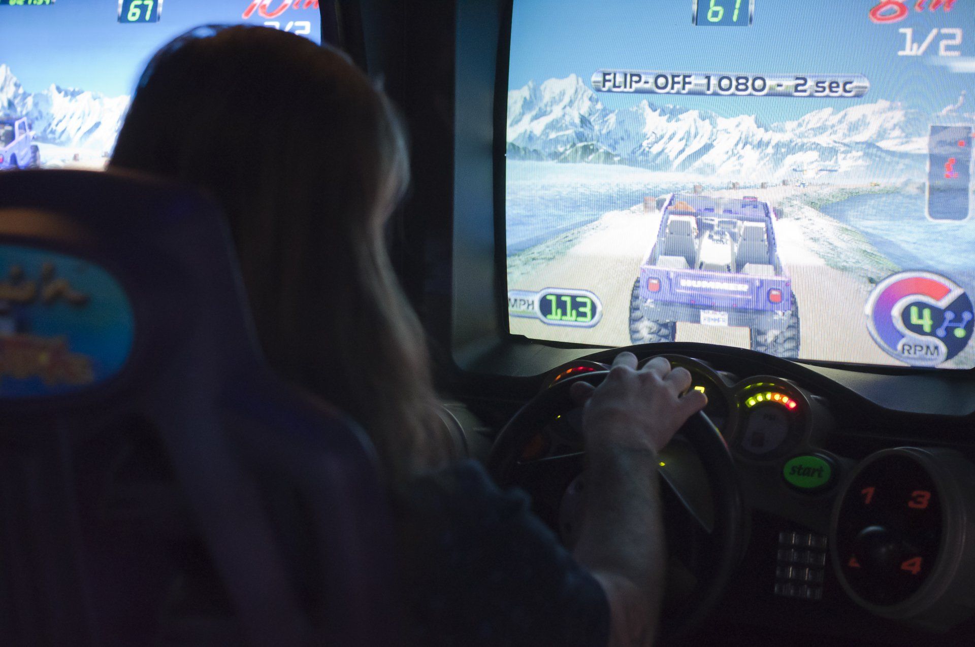 child playing racing arcade game