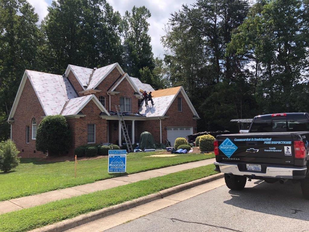 a truck is parked in front of a house that is being remodeled .