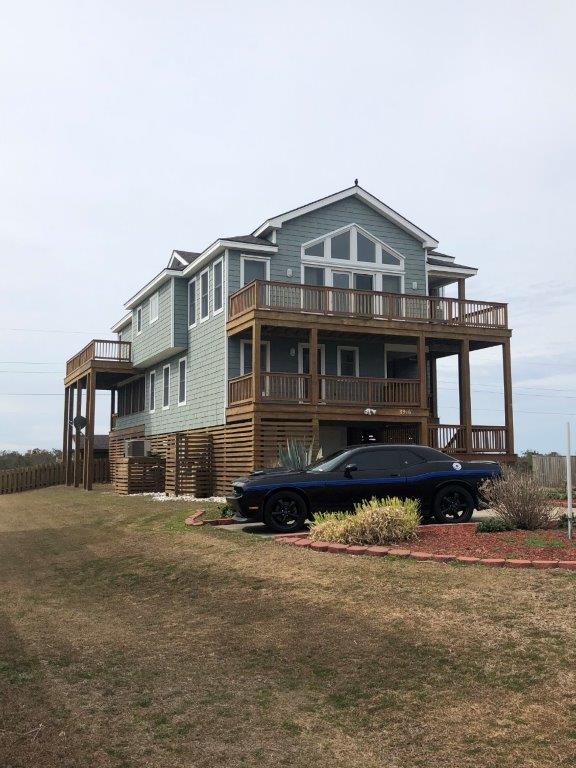 a large house with a car parked in front of it .