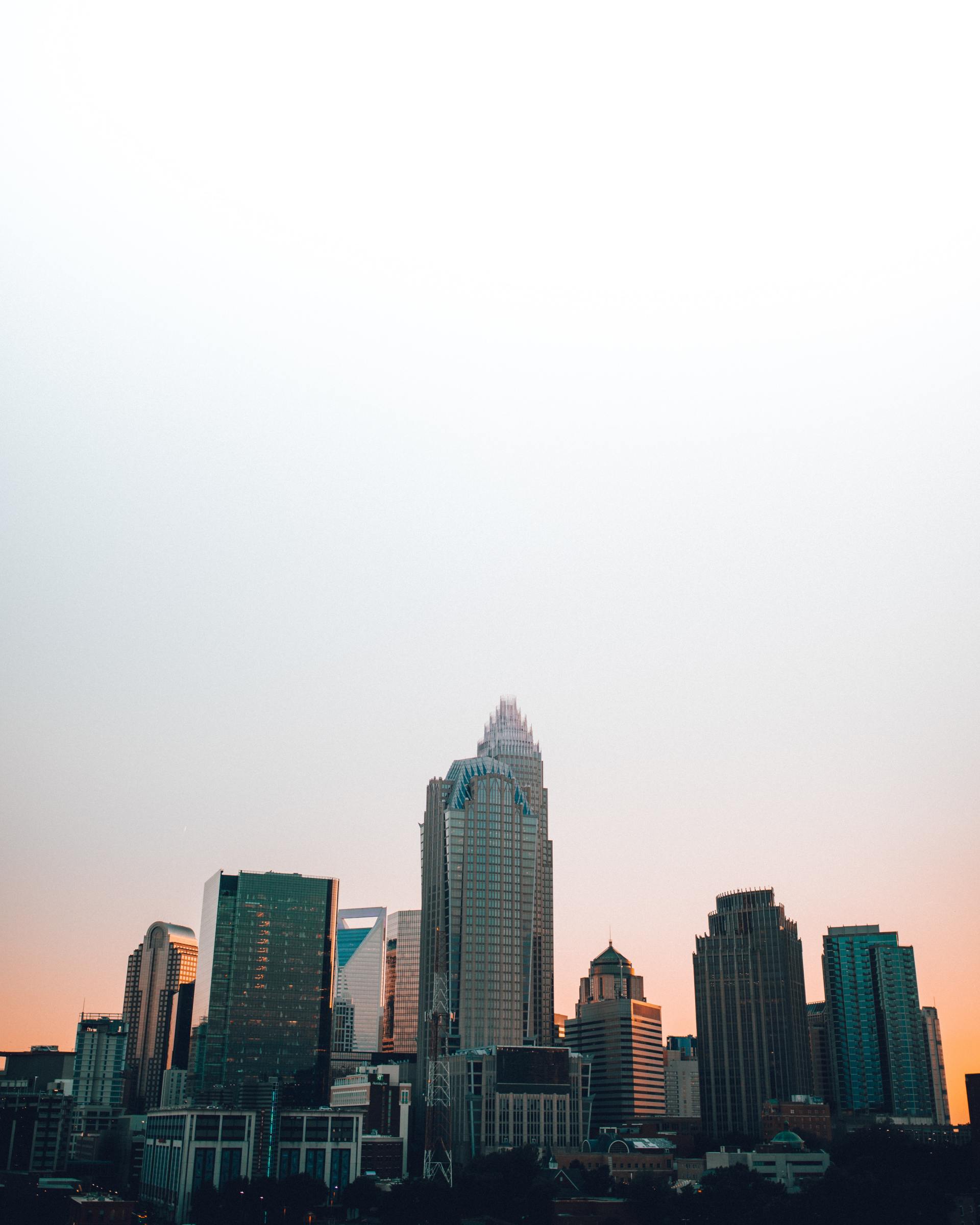 a city skyline at sunset with a white background .