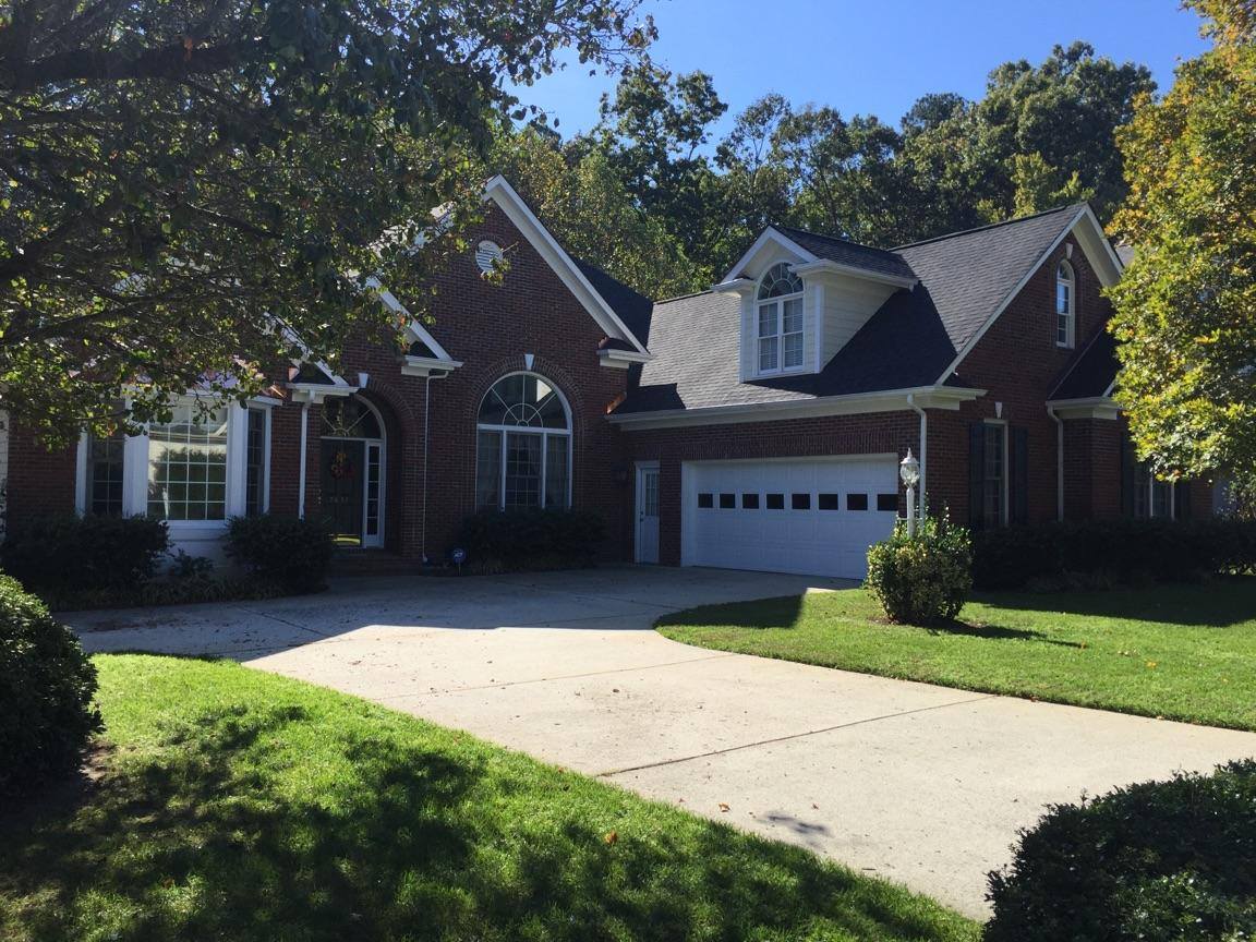 a large brick house with a white garage door