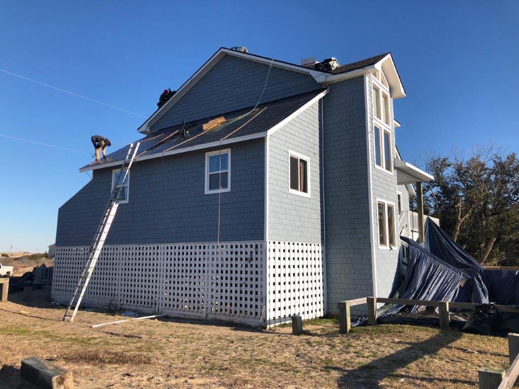 a large house with a ladder on the side of it .