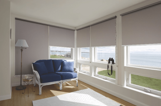 Holland ( Roller Blinds ) - Tweed Heads, NSW A living room with a blue couch and a view of the ocean - Tweed Heads, NSW