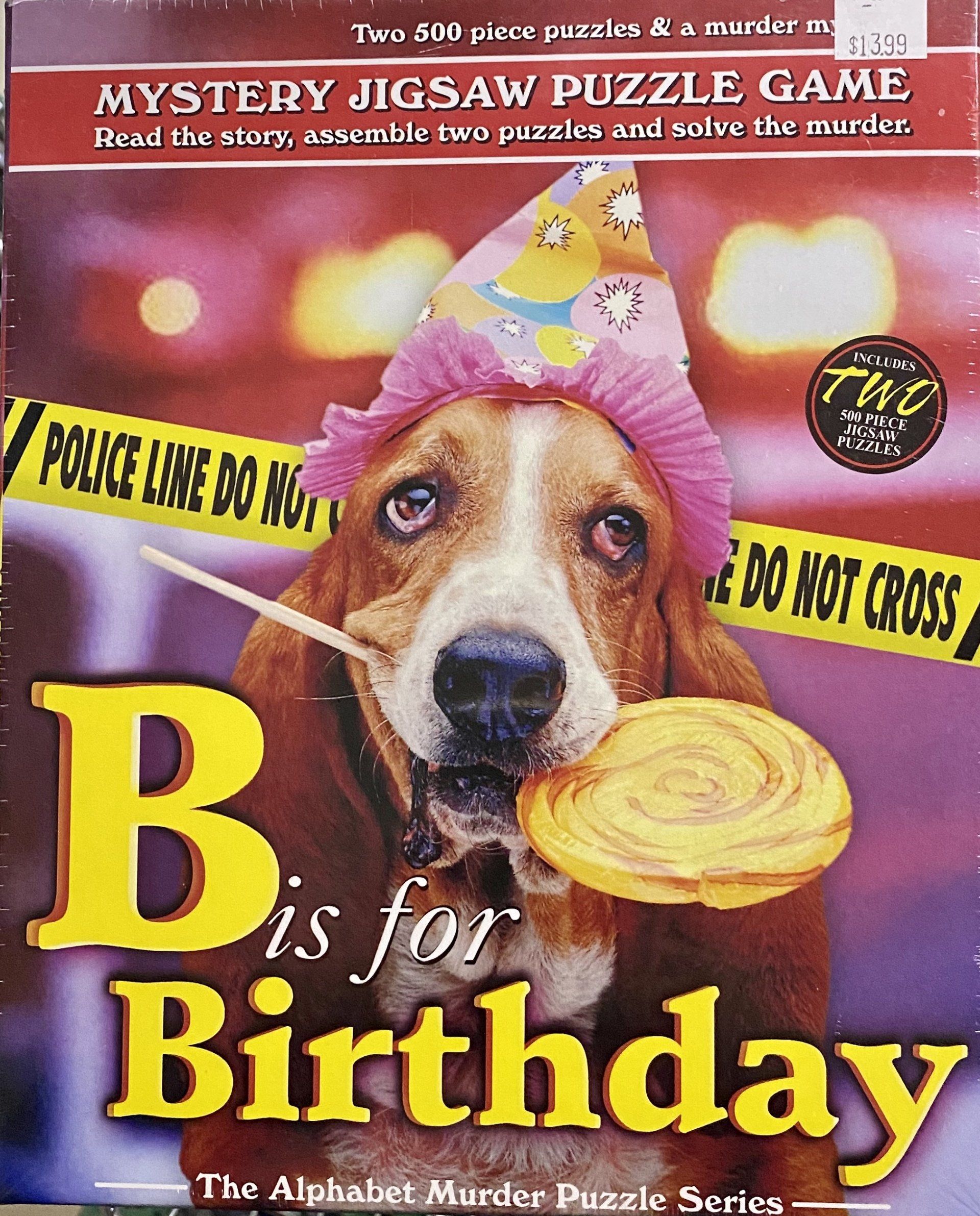 A basset hound wearing a pink party hat and holding a lollipop stands behind police caution tape on a mystery puzzle box.