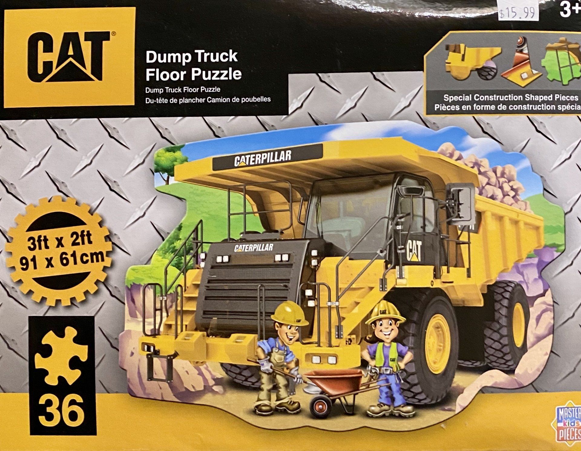 CAT Dump Truck 36-piece floor puzzle box showing a yellow construction truck and two workers in a landscape setting.