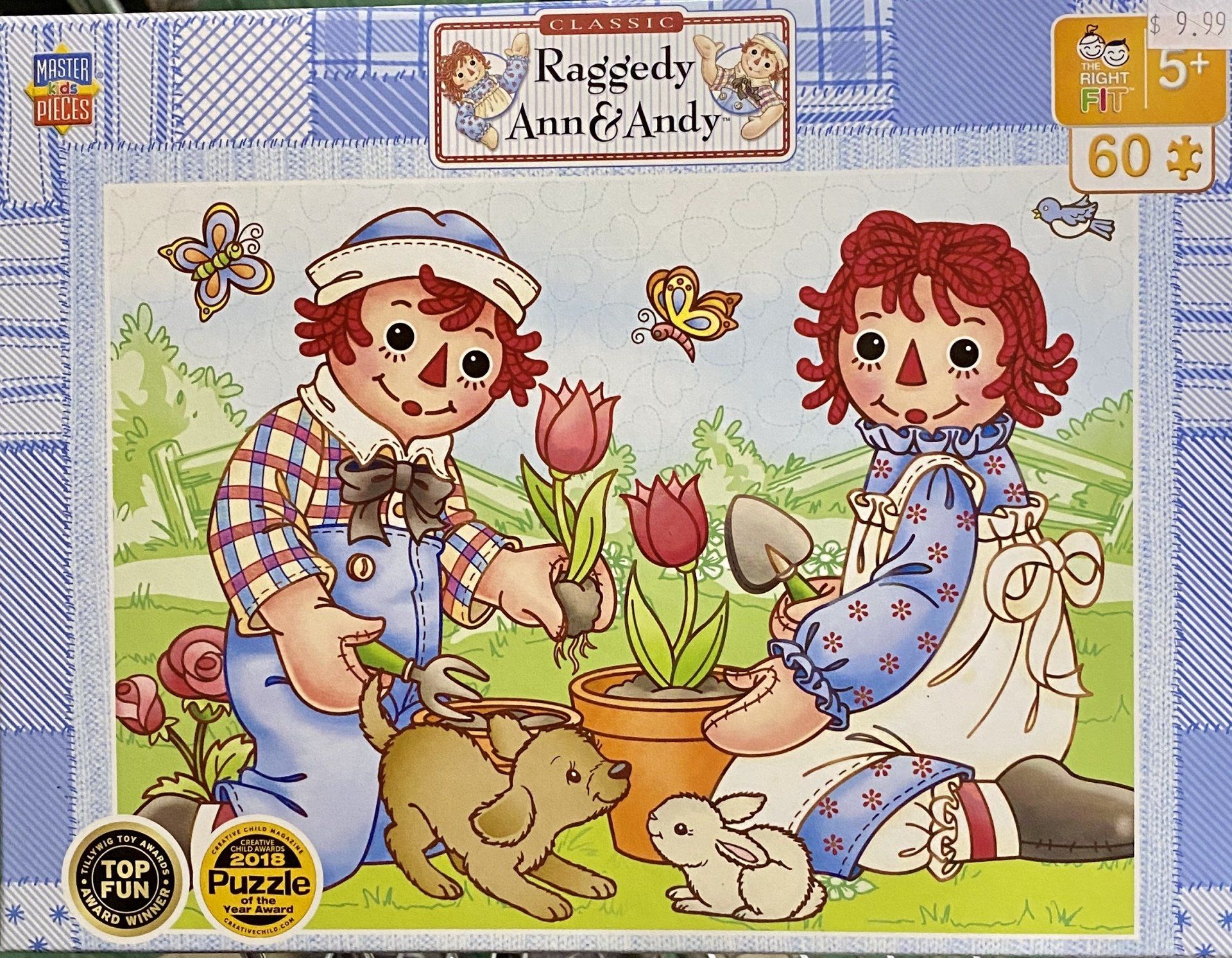 Raggedy Ann and Andy gardening together with a small dog and a rabbit in a grassy area with potted tulips and butterflies.
