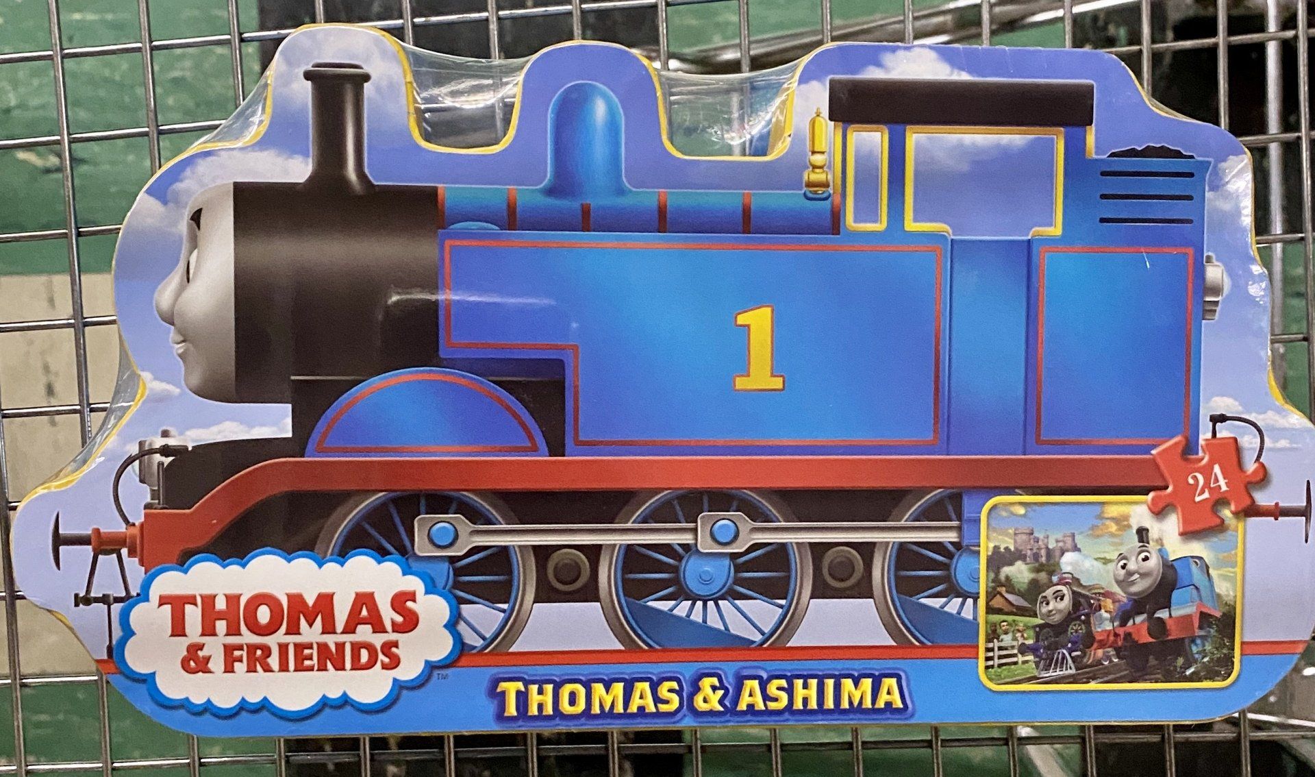 A Thomas the Tank Engine puzzle package featuring a blue locomotive with the number 1 and a small inset image of Thomas.