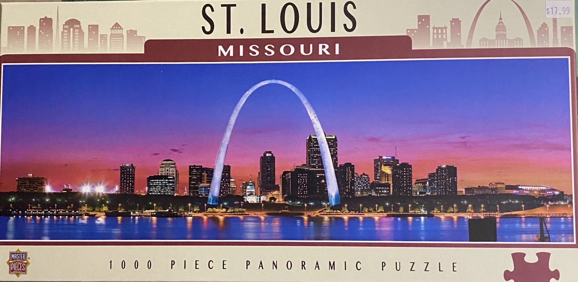 A panoramic puzzle box featuring the St. Louis skyline and Gateway Arch at dusk against a vibrant purple and orange sky.