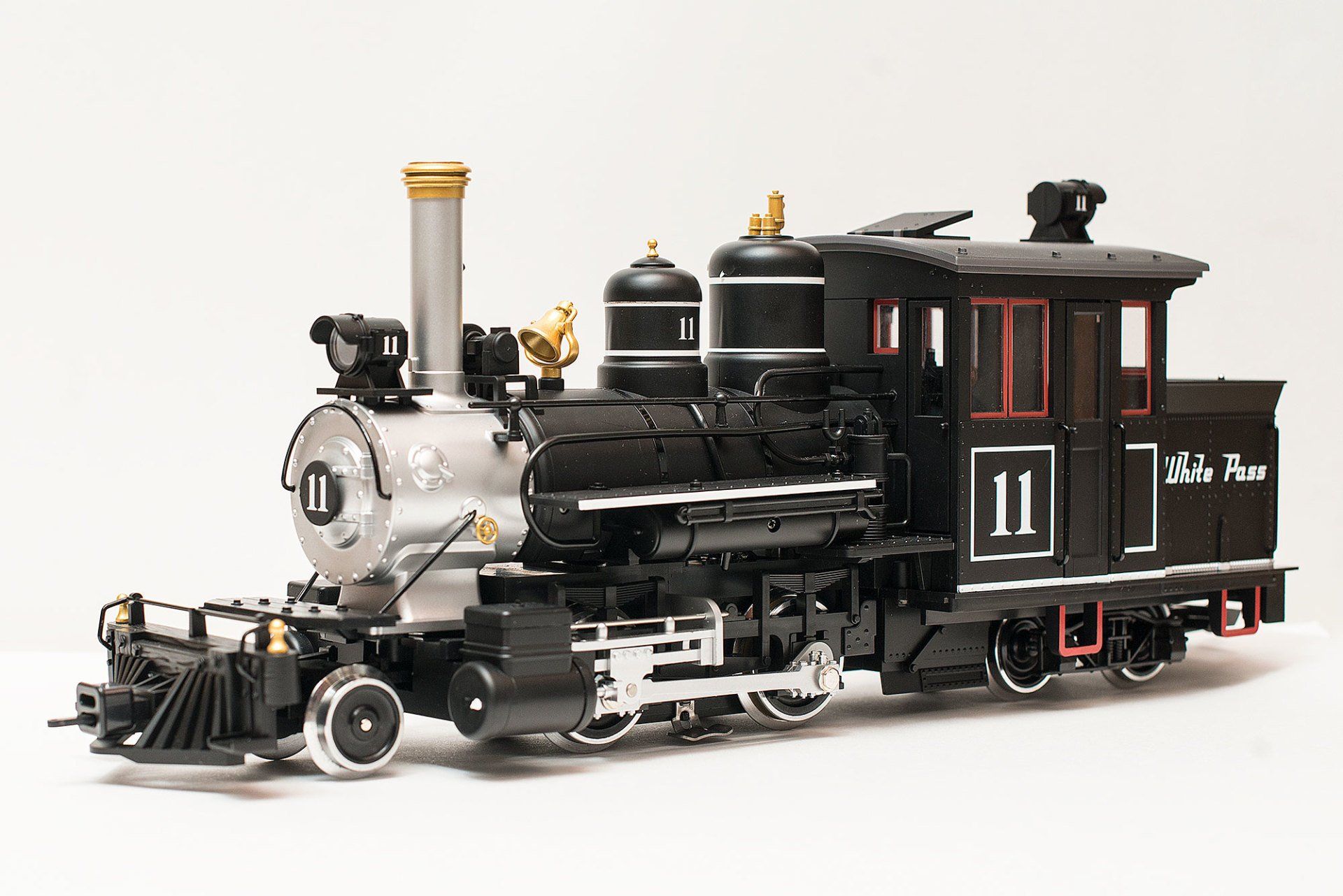 A model black and silver steam locomotive with the number 11 on the side, isolated against a white background.