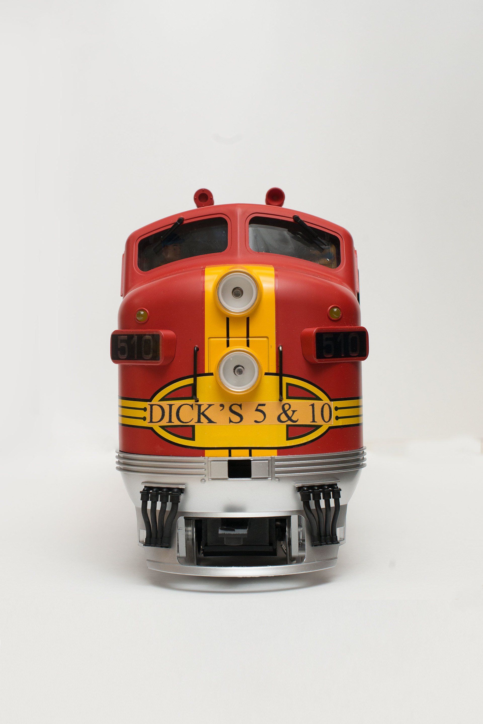 Front view of a red and yellow model train engine with